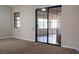 Living room with sliding glass doors leading to the outside and one window providing natural light at 904 Swift Bear St, Henderson, NV 89002