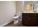 This powder room offers a modern vanity, fixtures, and tile flooring at 904 Swift Bear St, Henderson, NV 89002