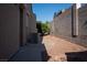 Exterior side yard featuring desert landscaping, walkway, air conditioning unit, and block wall for privacy at 904 Swift Bear St, Henderson, NV 89002