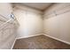Walk-in closet with white wire shelving and neutral colored walls and carpet at 904 Swift Bear St, Henderson, NV 89002