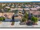 Aerial view of a neighborhood showcasing a home with solar panels on its roof at 9105 Chenin Ave, Las Vegas, NV 89129