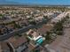 Stunning aerial view of a home with a sparkling pool and solar panels in a vibrant neighborhood at 9105 Chenin Ave, Las Vegas, NV 89129