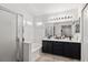 Bright bathroom featuring a double sink vanity, soaking tub, and glass shower at 9105 Chenin Ave, Las Vegas, NV 89129