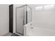 Bathroom featuring a white tiled bathtub and glass shower, perfect for relaxation at 9105 Chenin Ave, Las Vegas, NV 89129