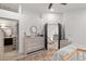View of a furnished bedroom leading to the hallway with a staircase, dresser, and bathroom at 9105 Chenin Ave, Las Vegas, NV 89129