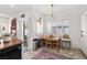 Bright dining area with a wooden table, direct access to backyard, and ample natural light at 9105 Chenin Ave, Las Vegas, NV 89129