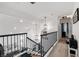 Well-lit hallway with modern light fixtures, black railings, and open view at 9105 Chenin Ave, Las Vegas, NV 89129