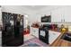 Stylish kitchen featuring a gas range, black appliances, and a colorful backsplash at 9105 Chenin Ave, Las Vegas, NV 89129