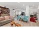 Bright, open-concept living room with modern decor, comfortable seating, and hardwood floors at 9105 Chenin Ave, Las Vegas, NV 89129