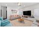 Cozy living room featuring comfortable seating, a large flat-screen TV, and a stylish coffee table at 9105 Chenin Ave, Las Vegas, NV 89129
