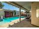 Inviting pool area with covered patio, swing and lush greenery at 9105 Chenin Ave, Las Vegas, NV 89129