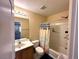 Bathroom with toilet, sink, vanity, shower with curtain, and an open doorway at 9148 Patrick Henry Ave, Las Vegas, NV 89149