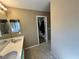 Bathroom featuring dual sinks with ample counter space, leading to a walk-in closet for storage at 9148 Patrick Henry Ave, Las Vegas, NV 89149