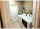 Bright laundry room with white washer, dryer, and a white utility door at 9148 Patrick Henry Ave, Las Vegas, NV 89149