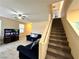 Inviting living room with ceiling fan and staircase access to the next level at 9148 Patrick Henry Ave, Las Vegas, NV 89149
