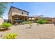 Spacious backyard with low maintenance desert landscaping, a covered patio, and privacy fence at 9163 W Torino Ave, Las Vegas, NV 89148