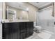 Bathroom with walk-in shower, dark cabinets and modern vanity at 9163 W Torino Ave, Las Vegas, NV 89148