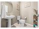 Cozy powder bathroom features a pedestal sink, framed art, and storage rack at 9163 W Torino Ave, Las Vegas, NV 89148