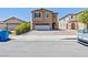 Two-story home with a two-car garage and paved driveway, close to the street at 9163 W Torino Ave, Las Vegas, NV 89148