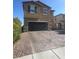 Inviting two-story home featuring a finished two-car garage and a beautifully paved driveway at 9163 W Torino Ave, Las Vegas, NV 89148