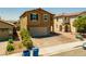 Two-story home with a two-car garage and a paved driveway at 9163 W Torino Ave, Las Vegas, NV 89148