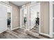 Hallway with wood-look flooring leading to bedrooms with white doors and trim at 9163 W Torino Ave, Las Vegas, NV 89148