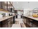 Modern kitchen with dark cabinets, stainless steel appliances, granite countertops, and ample storage space at 9163 W Torino Ave, Las Vegas, NV 89148