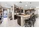 Spacious kitchen with an island and breakfast bar, seamlessly flowing into the dining and living areas at 9163 W Torino Ave, Las Vegas, NV 89148