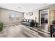 Inviting living room with a leather sofa, wood-style floors, and natural light at 9163 W Torino Ave, Las Vegas, NV 89148