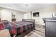 Cozy bedroom with wood-style floors, ensuite bathroom, and comfortable furnishings at 9163 W Torino Ave, Las Vegas, NV 89148
