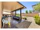 Enjoy outdoor living on this covered patio with ample seating and a well-maintained yard at 9163 W Torino Ave, Las Vegas, NV 89148