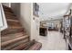 Wooden staircase leads to the upper level, with an open view of the living spaces below at 9163 W Torino Ave, Las Vegas, NV 89148
