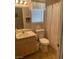 A functional bathroom with a single sink vanity, toilet, and shower with curtain at 9225 Lady Palm Ct, Las Vegas, NV 89147