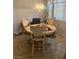A cozy dining area with a round table, four chairs, and a chandelier at 9225 Lady Palm Ct, Las Vegas, NV 89147