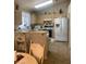 Bright kitchen featuring white appliances, light wood cabinets, and a breakfast bar at 9225 Lady Palm Ct, Las Vegas, NV 89147