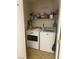 A functional laundry room with a washer, dryer, shelving, and storage at 9225 Lady Palm Ct, Las Vegas, NV 89147
