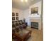 A stylish living room with a fireplace, a large sofa, and neutral-toned decor at 9225 Lady Palm Ct, Las Vegas, NV 89147