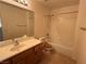 Bathroom featuring a sink with wood cabinets and a bathtub with glass doors at 925 Scarlet Haze Ave, Las Vegas, NV 89183