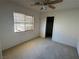 Modest bedroom featuring carpet, a window with blinds, and a ceiling fan at 925 Scarlet Haze Ave, Las Vegas, NV 89183