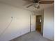 Clean bedroom with carpet, ceiling fan, and white door leading to the hallway at 925 Scarlet Haze Ave, Las Vegas, NV 89183