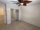 Bright bedroom features carpet, ceiling fan, and mirrored sliding closet doors at 925 Scarlet Haze Ave, Las Vegas, NV 89183