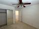 A cozy bedroom featuring carpet, ceiling fan, and mirrored sliding closet doors at 925 Scarlet Haze Ave, Las Vegas, NV 89183