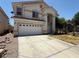 Two story home with a white garage door and concrete driveway at 925 Scarlet Haze Ave, Las Vegas, NV 89183