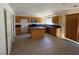 Functional kitchen featuring tile floors, wooden cabinets, and center island at 925 Scarlet Haze Ave, Las Vegas, NV 89183