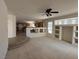 Open-concept living room with carpet and tile flooring adjacent to kitchen at 925 Scarlet Haze Ave, Las Vegas, NV 89183
