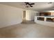 Open-concept living room with carpet and tile flooring adjacent to kitchen at 925 Scarlet Haze Ave, Las Vegas, NV 89183