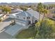 An aerial view of a home with an attached three-car garage, a lawn, and a detached shop at 9435 Westwind Rd, Las Vegas, NV 89139