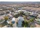 Aerial view of a neighborhood featuring a home with detached garage, pool, and well-maintained landscaping at 9435 Westwind Rd, Las Vegas, NV 89139