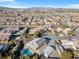 An aerial view of the neighborhood with a desert landscape featuring many homes, including one with a pool at 9435 Westwind Rd, Las Vegas, NV 89139
