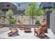 The backyard features Adirondack chairs around a modern fire pit with manicured landscaping at 9451 Lunar Ray St, Las Vegas, NV 89143